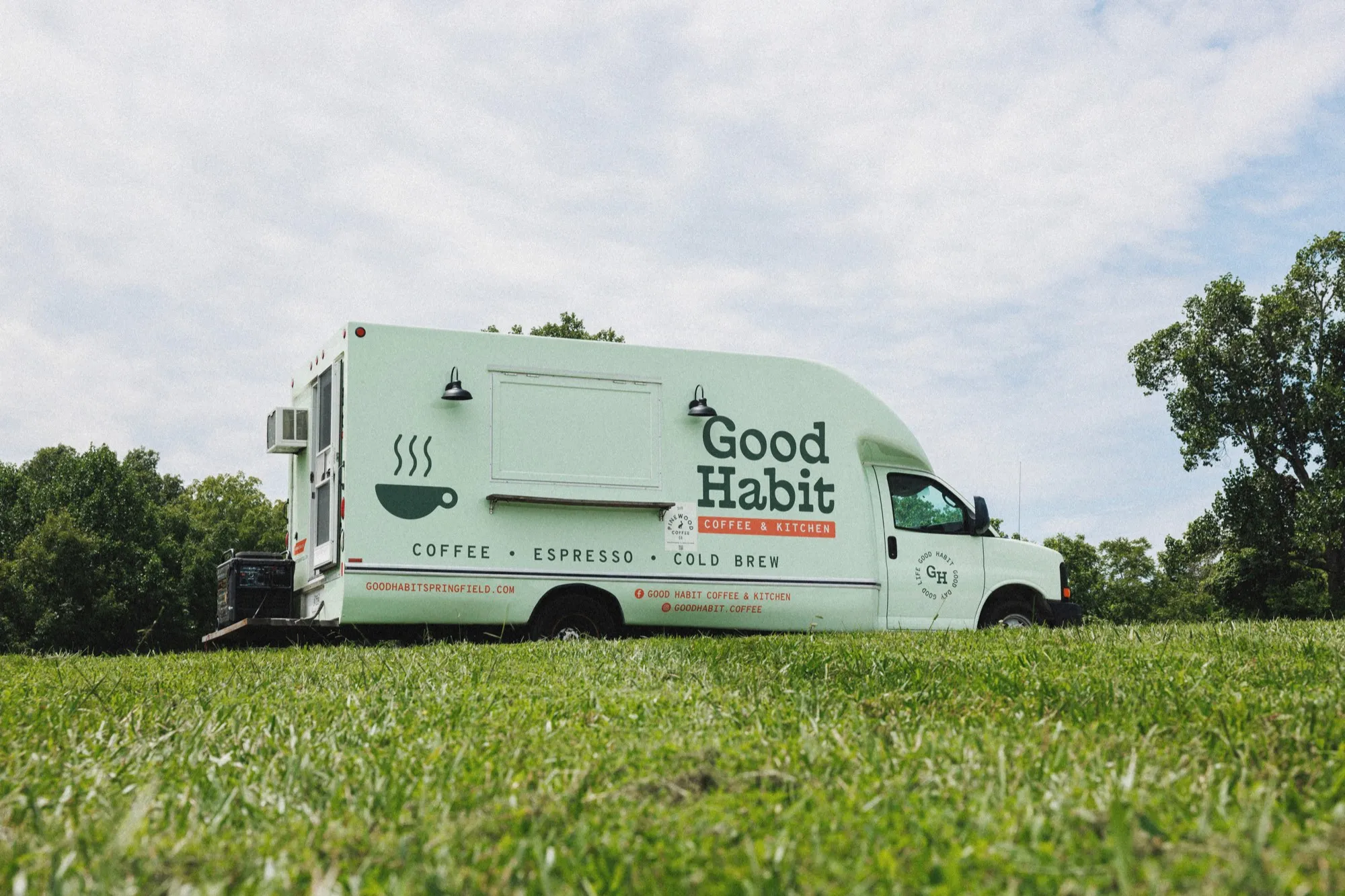 Good Habit food truck parked in a grass field