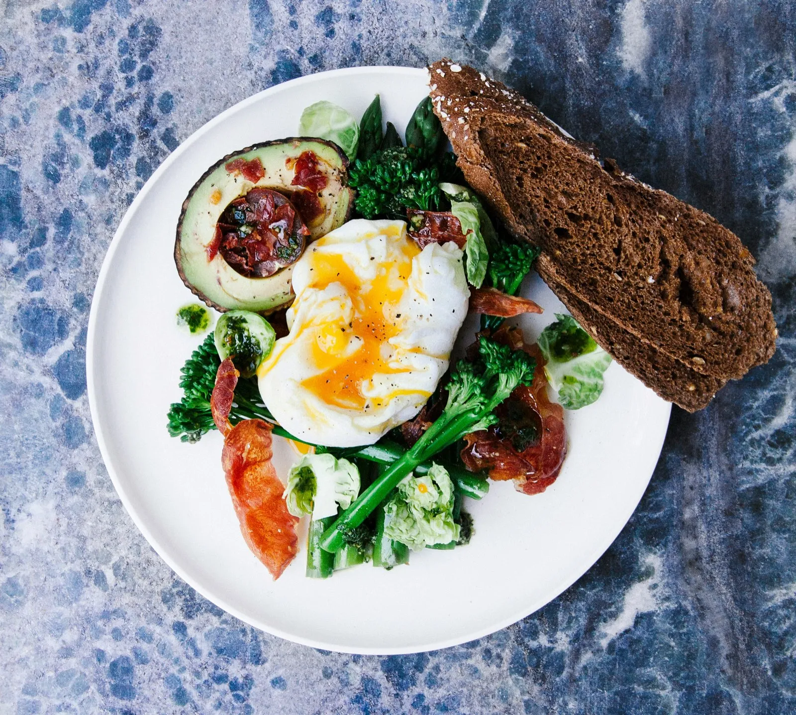 Poached egg with avocado, broccolini and toast